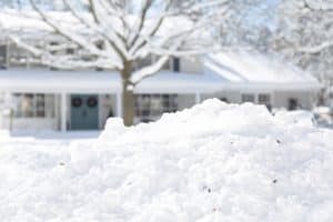 Snow-covered yard in front of a house in winter