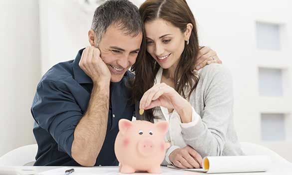 Couple reviewing home financing options with a piggy bank
