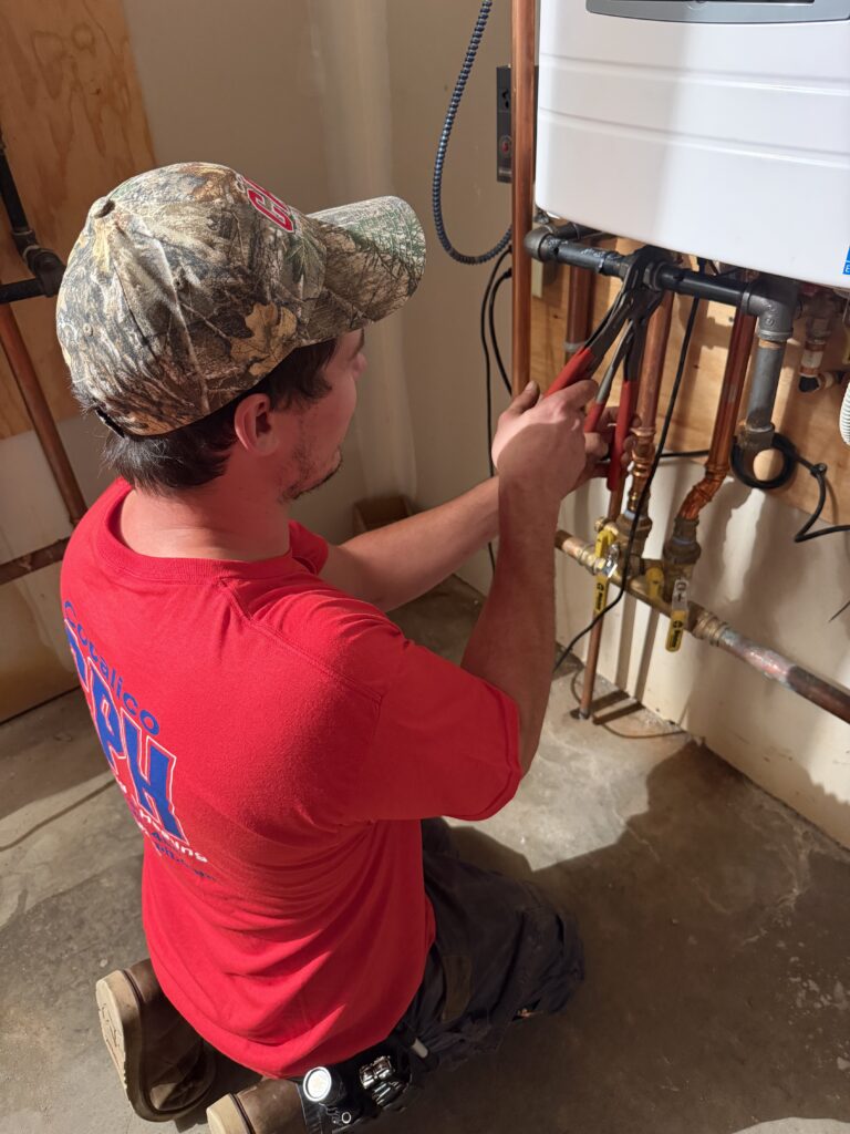 Plumber installing a tankless water heater in Denver, PA