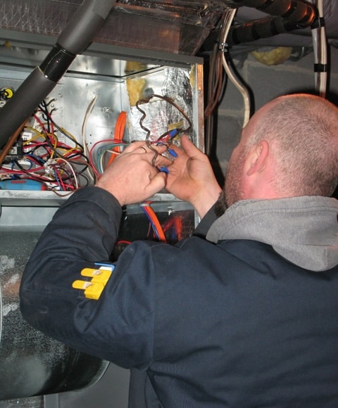 Technician working on a furnace in Denver, PA