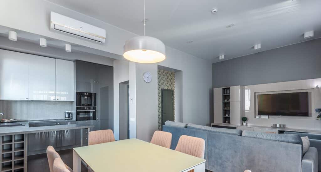 Ductless mini-split unit mounted in a modern kitchen and dining area