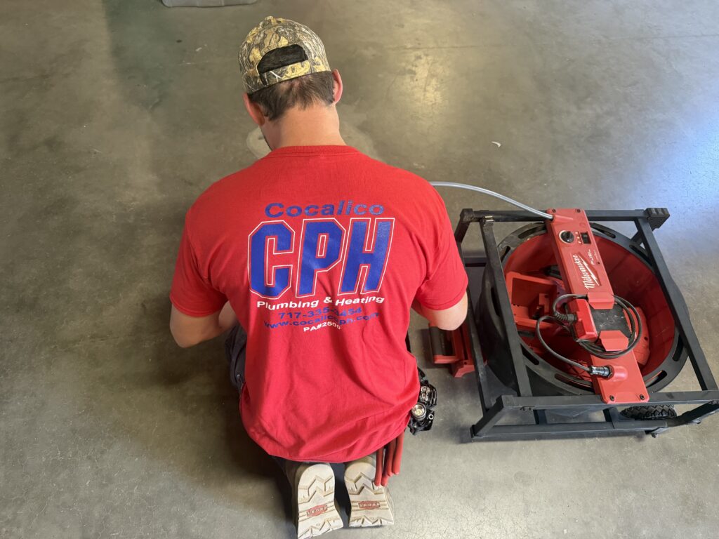 Plumber using a drain cleaning machine in Lititz, PA