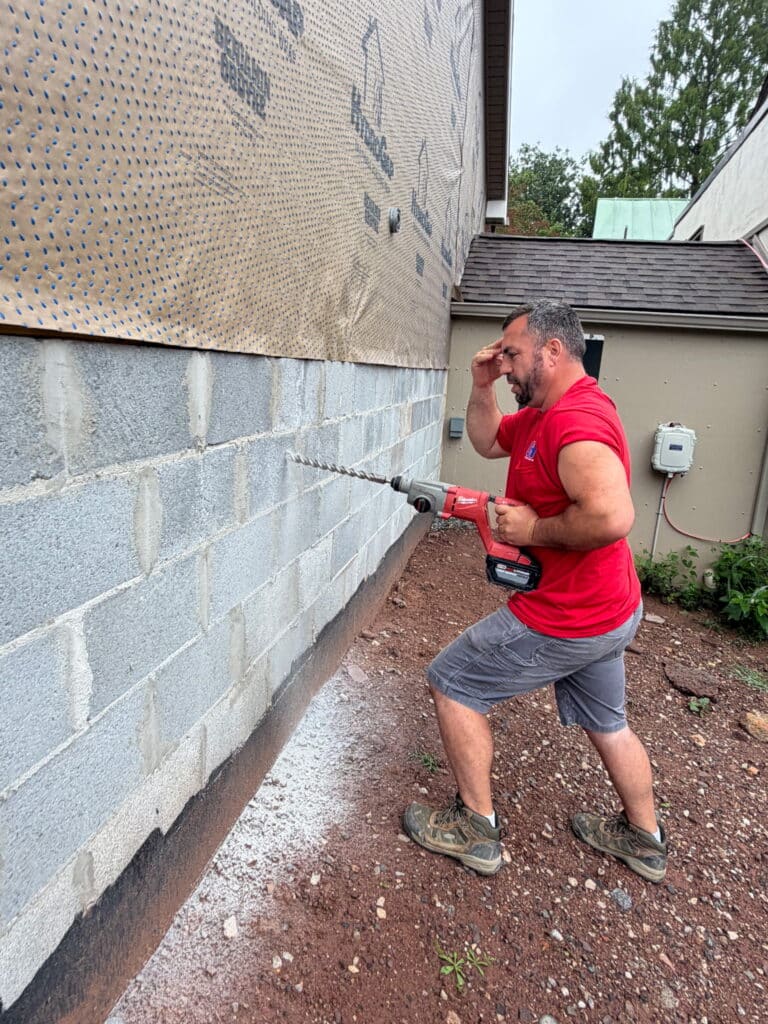 Technician drilling through a foundation wall in Reading, PA