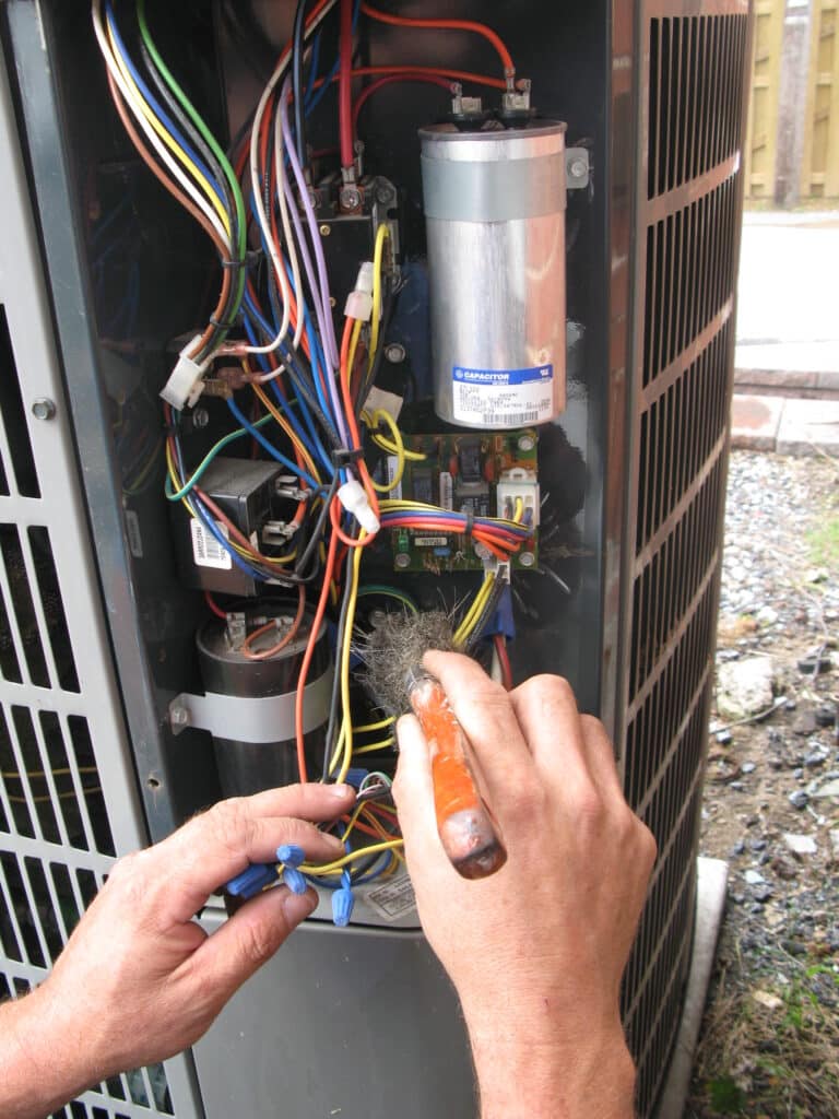 Technician wiring an outdoor AC unit in Reinholds, PA