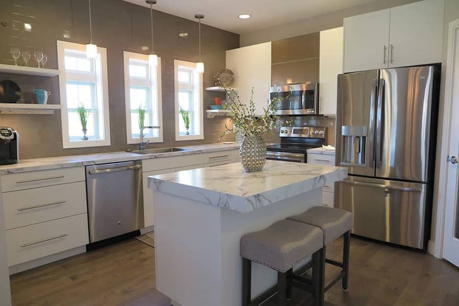 Remodeled kitchen with island and stainless appliances
