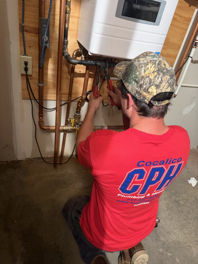 Plumber installing a tankless water heater in Ephrata, PA